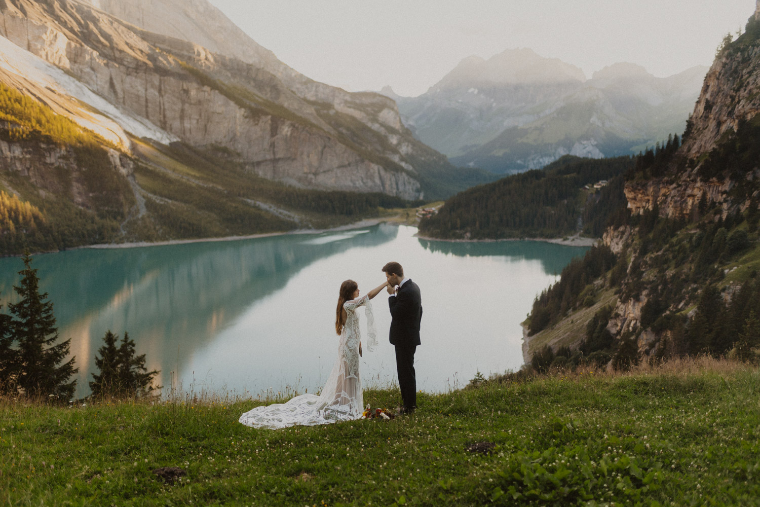 Bride and Groom reading Vows to each other at the Oeschinenlake in Switzerland at sunset.