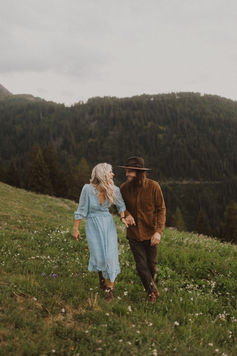 Paarfotoshooting im Wallis in den Bergen. Sie trägt ein blaues langes Kleid.