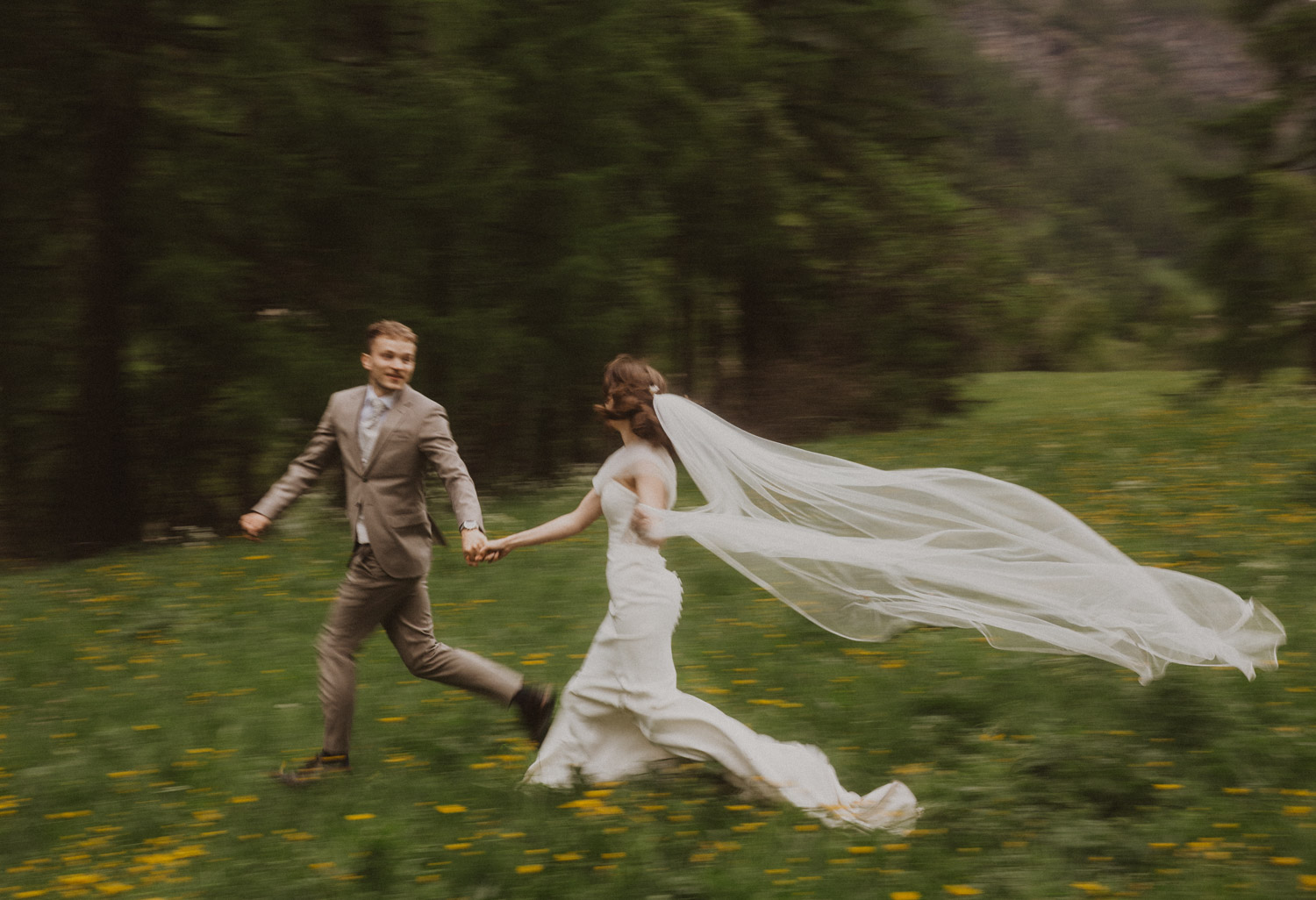 Zermatt Elopement in Switzerland Couple runs through a flower field at their elopement in Zermatt