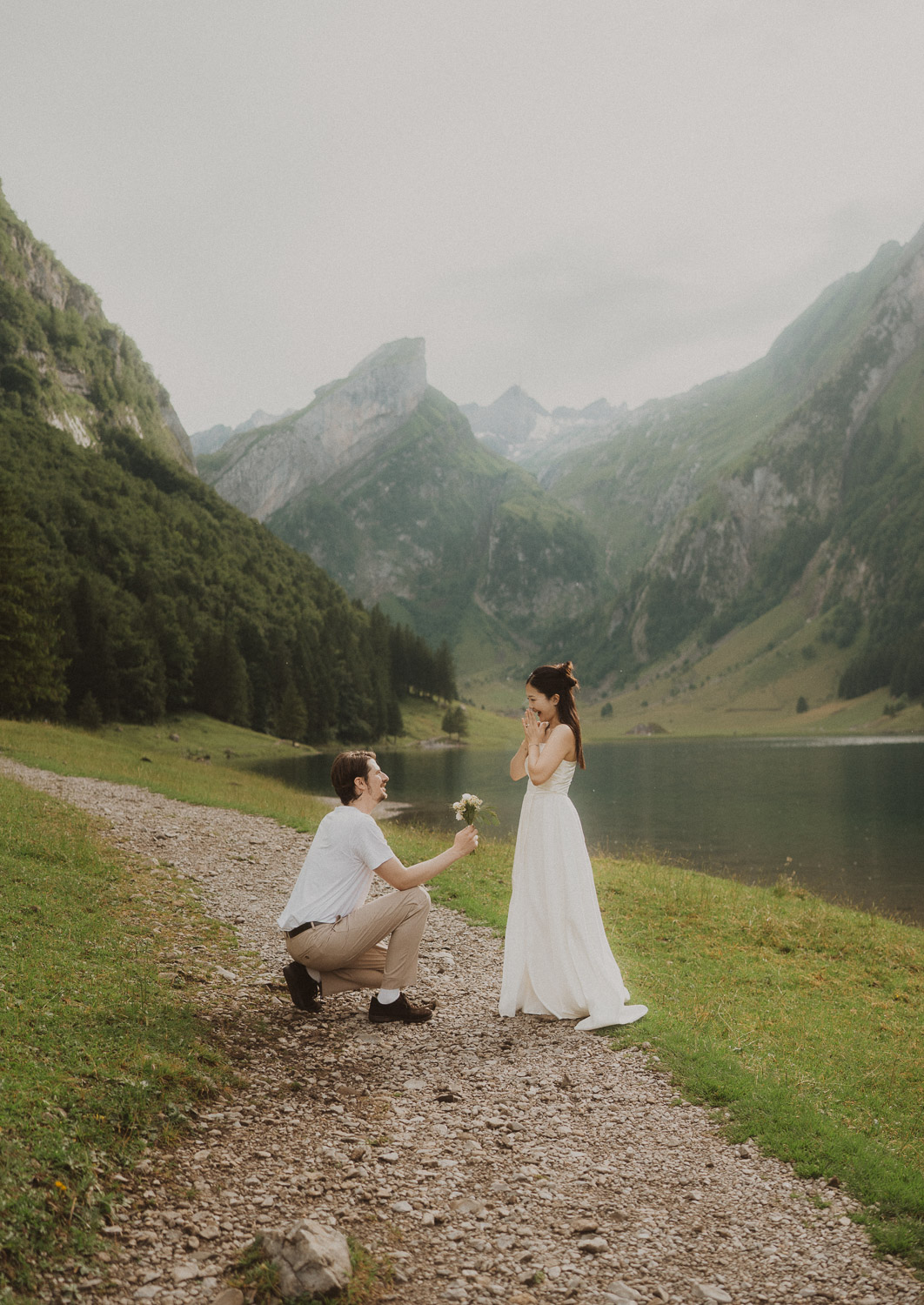 Couple proposing at Seealpsee in Appenzell, photographed by an elopement and proposal photographer.