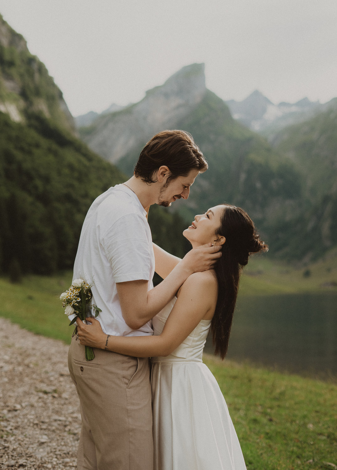 Couple holding each other at Seealpsee in Appenzell, photographed by an elopement and proposal photographer.