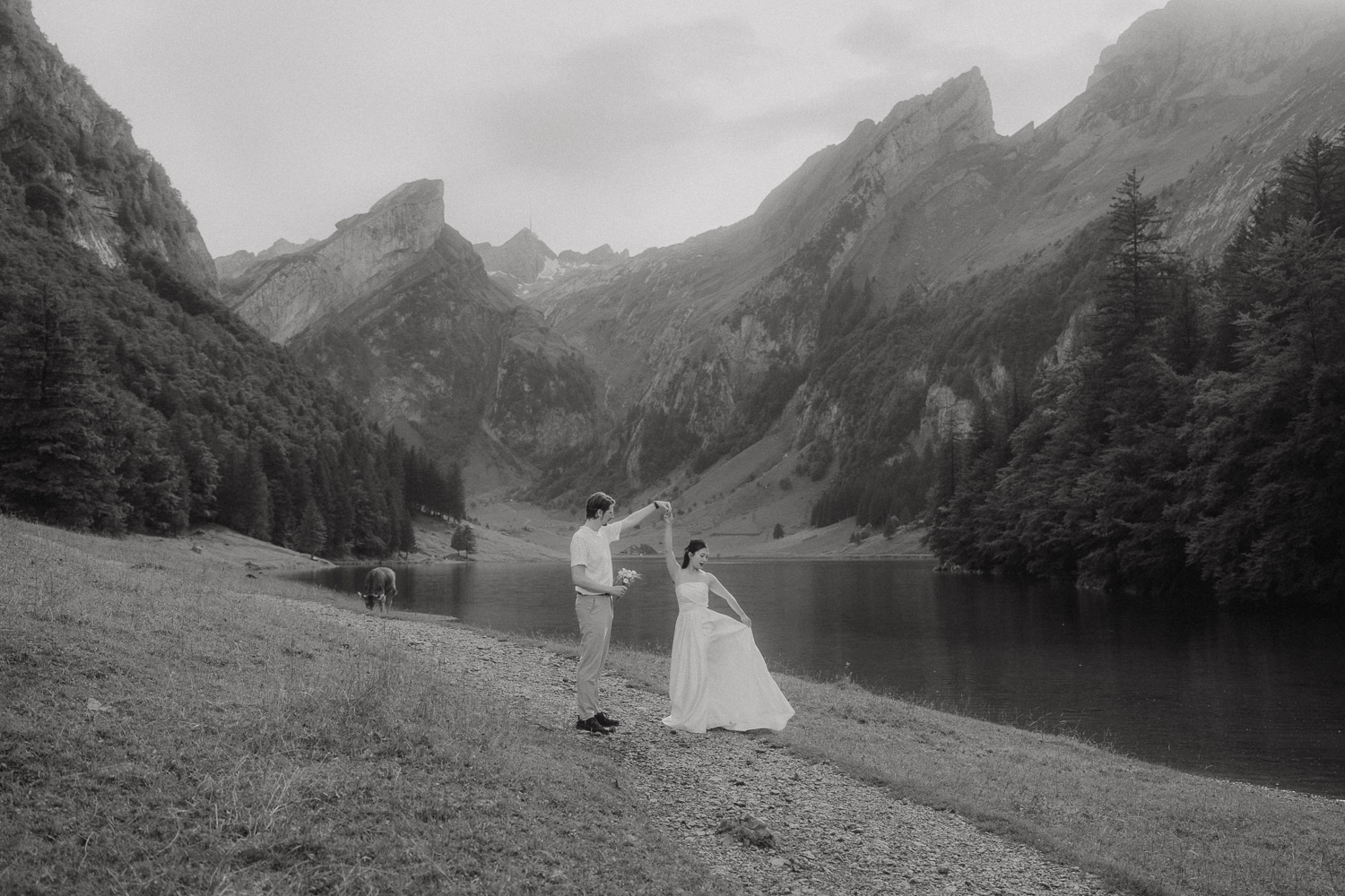 Couple eloping and dancing at Seealpsee in Appenzell, photographed by an elopement and proposal photographer.