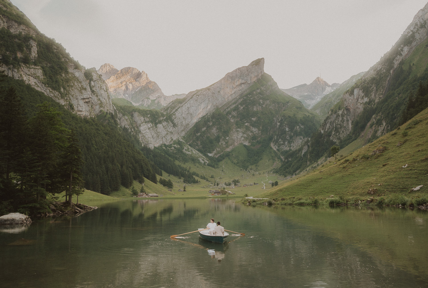 Couple eloping in a row boat at Seealpsee in Appenzell, photographed by an elopement and proposal photographer.