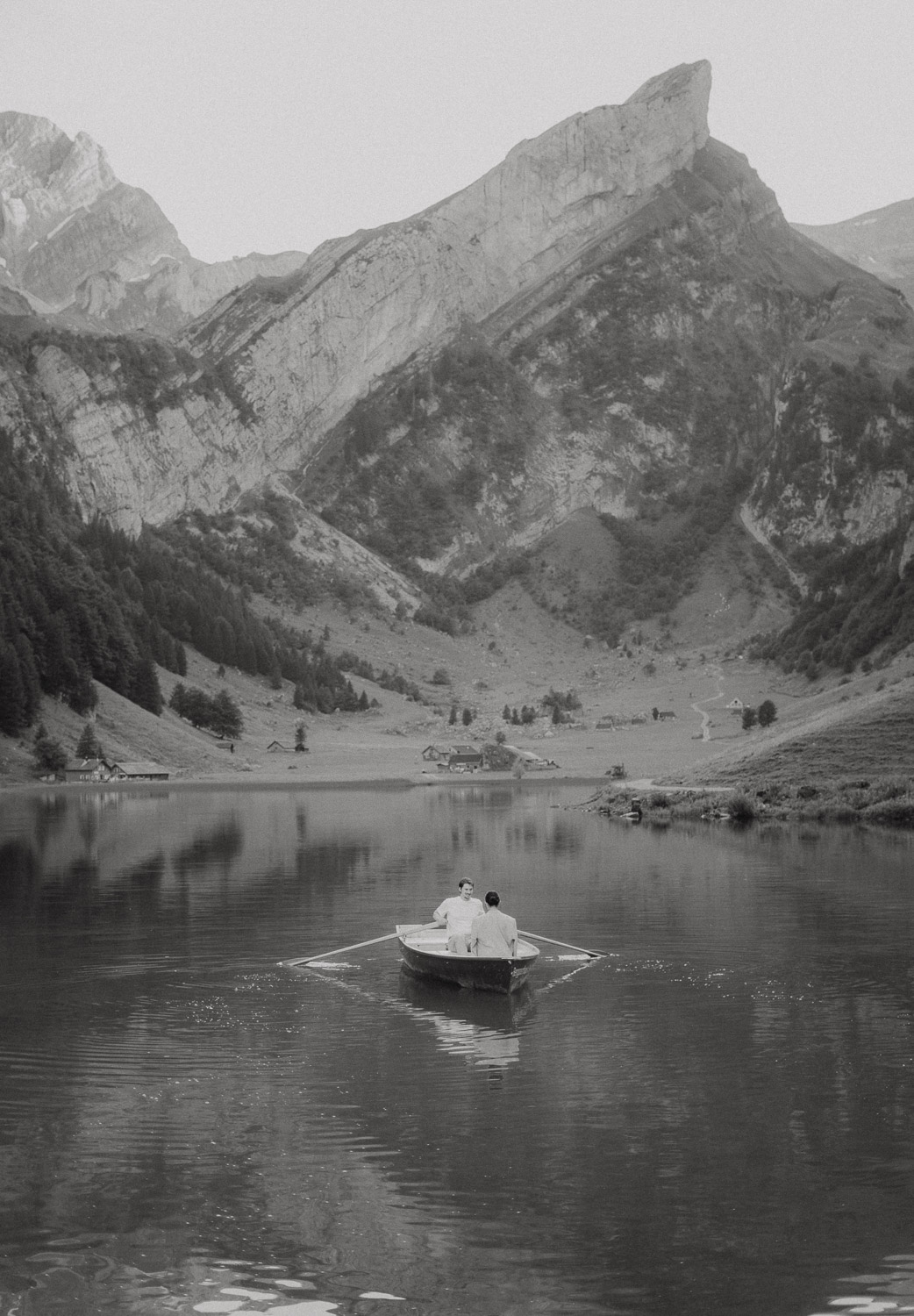 Couple eloping in a row boat at Seealpsee in Appenzell, photographed by an elopement and proposal photographer.
