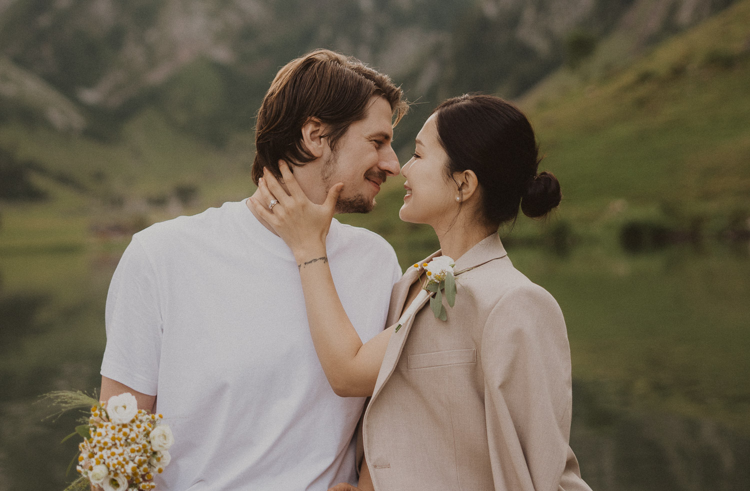 Couple eloping in a row boat at Seealpsee in Appenzell, photographed by an elopement and proposal photographer.