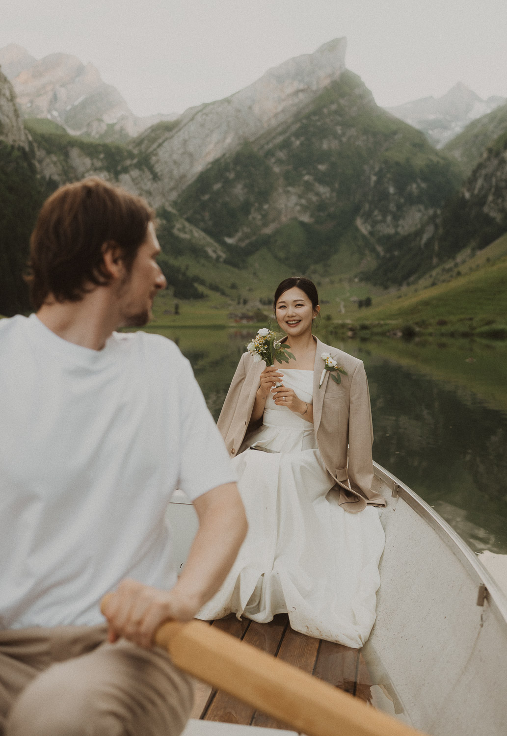 Couple eloping in a row boat at Seealpsee in Appenzell, photographed by an elopement and proposal photographer.