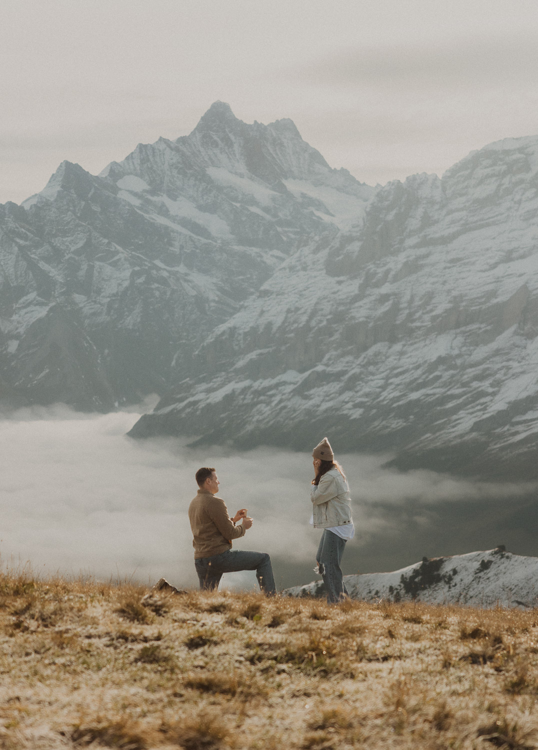 Surprise proposal photography in the Jungfrauregion with alpine mountain scenery and natural outdoor setting in daylight.