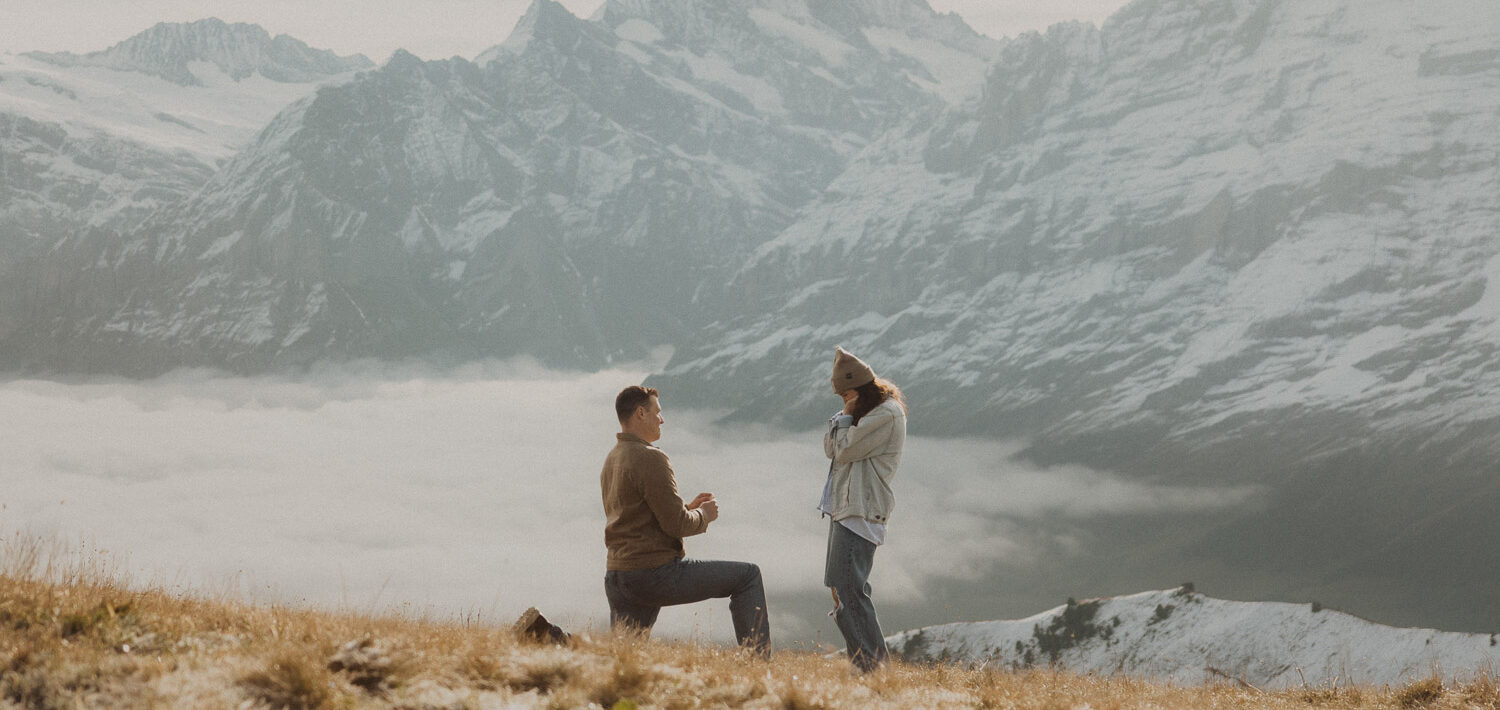 Surprise proposal photography in the Jungfrauregion with alpine mountain scenery and natural outdoor setting in daylight.