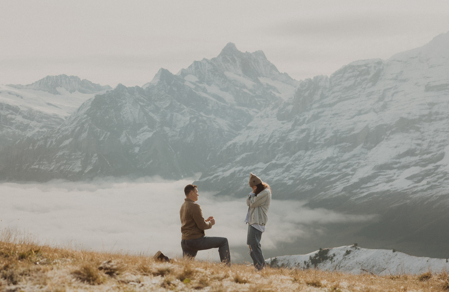 Surprise proposal photography in the Jungfrauregion with alpine mountain scenery and natural outdoor setting in daylight.