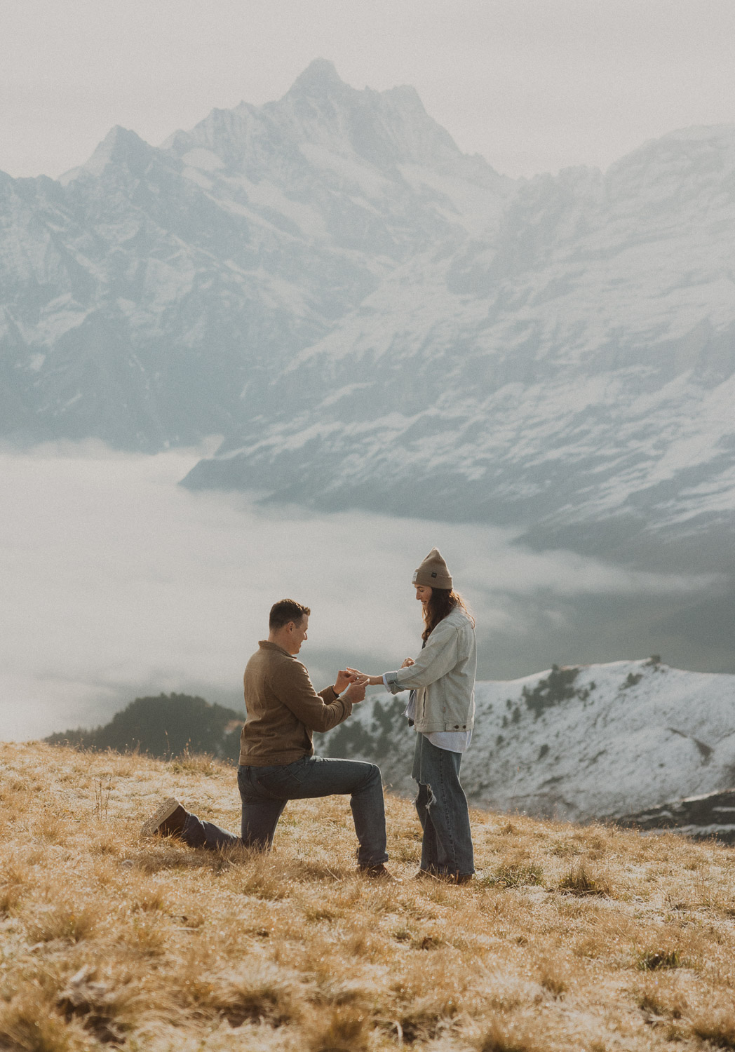 Surprise proposal photography in the Jungfrauregion with alpine mountain scenery and natural outdoor setting in daylight.