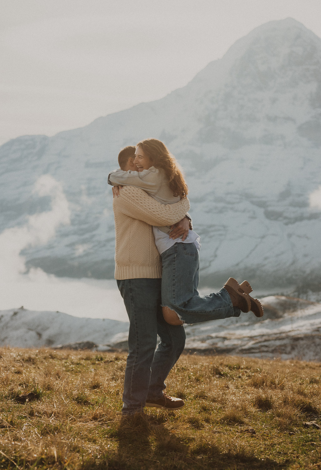 Couple at a surprise proposal photography session in the Jungfrauregion with alpine mountain scenery and natural outdoor setting in daylight.