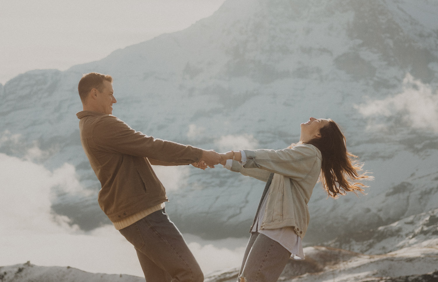 Couple at a surprise proposal photography session in the Jungfrauregion with alpine mountain scenery and natural outdoor setting in daylight.
