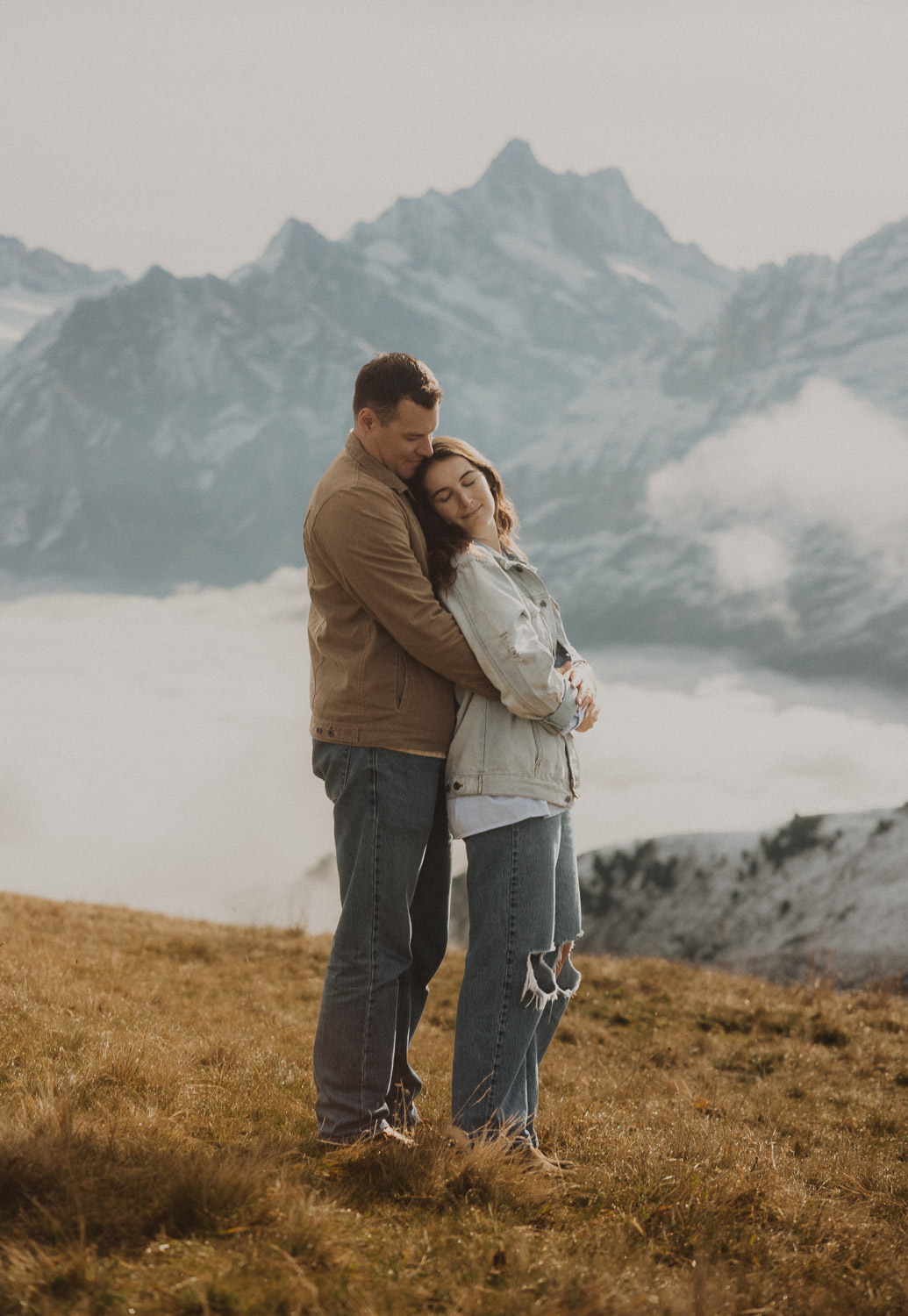 Couple at a surprise proposal photography session in the Jungfrauregion with alpine mountain scenery and natural outdoor setting in daylight.