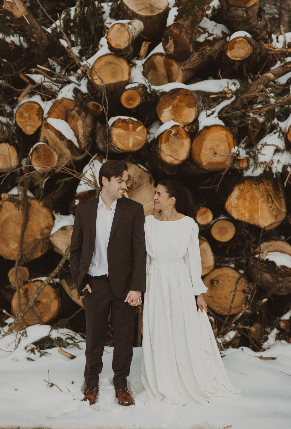 Couple during an elopement photography session in Lucerne with snow-covered alpine mountains and a lakeside backdrop.